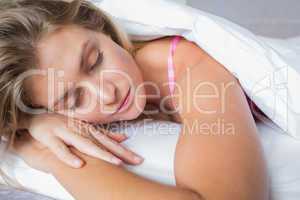 Peaceful blonde lying on her bed asleep