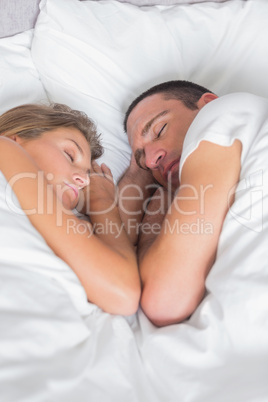 Cute couple asleep together in bed