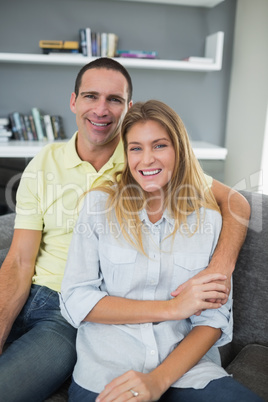 Happy couple sitting on their couch