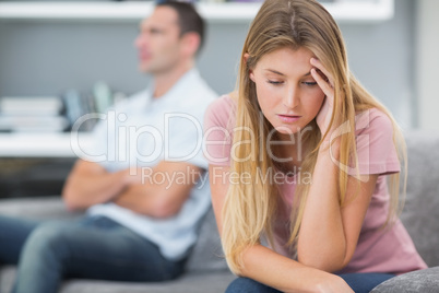 Couple not talking after a fight on the sofa