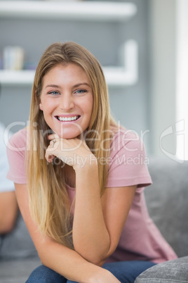 Happy woman sitting on couch