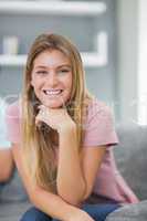 Happy woman sitting on couch