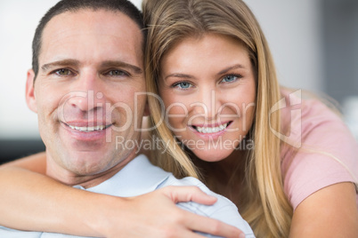 Woman hugging her partner from behind