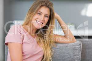 Beautiful blonde sitting on her couch