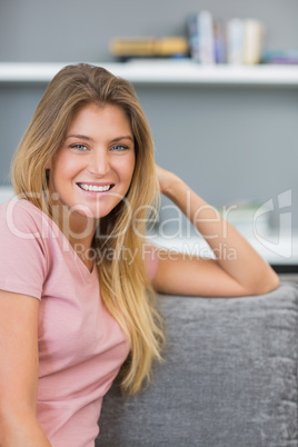 Pretty blonde sitting on her couch