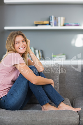 Pretty blonde sitting on her sofa