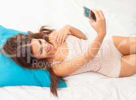brunette woman on her bed