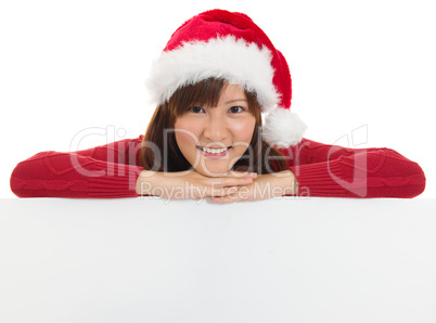 Christmas santa woman showing blank billboard sign.