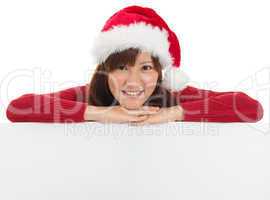 Christmas santa woman showing blank billboard sign.