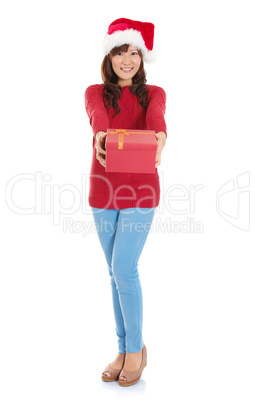 Full body Christmas woman holding gift wearing Santa hat.