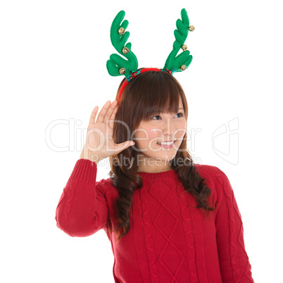 Young Asian Christmas Girl listening