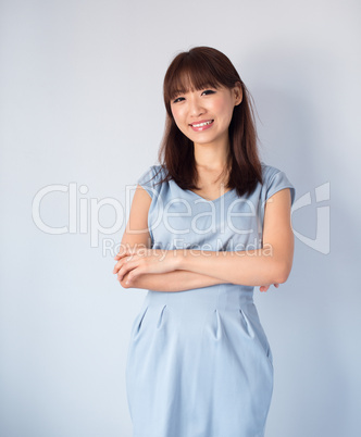 Asian woman isolated on blue background.