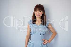 Cute Asian woman isolated on blue background.