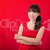 Portrait of cute Asian woman over red background