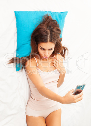 brunette woman on her bed