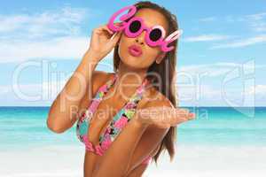 young beautiful woman enjoying the sun on the beach wearing cool glasses