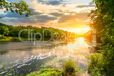 Sunset over the river in the forest