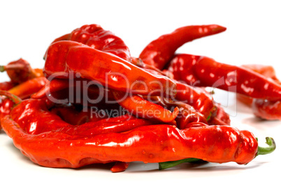 red chili peppers with water drops on white background