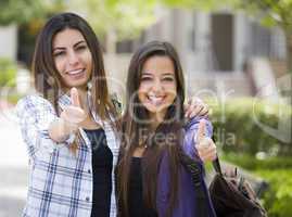 Mixed Race Female Students on School Campus With Thumbs Up