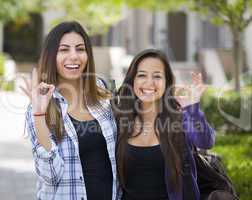 Mixed Race Female Students on School Campus With Okay Sign