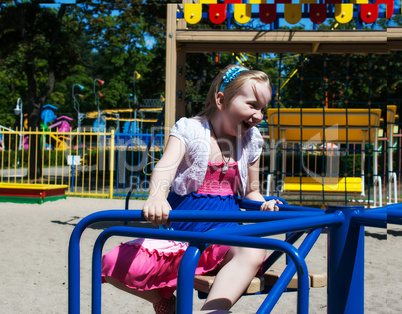 girl riding on a carousel