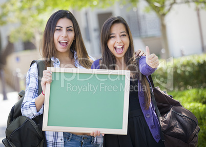 Mixed Race Female Students with Thumbs Up Holding Blank Chalkboa