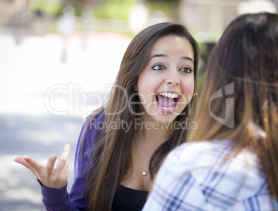 Expressive Young Mixed Race Female Sitting and Talking with Girl