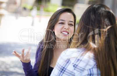 Expressive Young Mixed Race Female Sitting and Talking with Girl