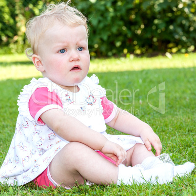 Baby sitting alone in the meadow