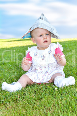 Baby sitting alone in the meadow