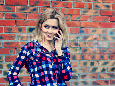 young blond girl talking on the phone