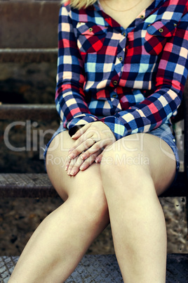 young girl is sitting on the stairs