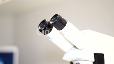 Male - looking in microscope - near