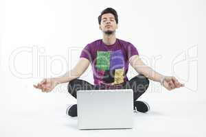 Man meditating infront of a laptop