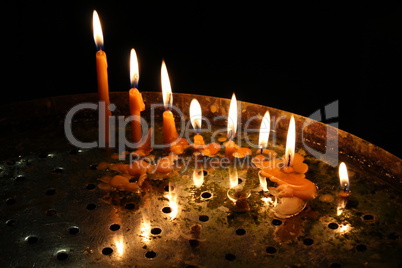 row of bright burning church candles