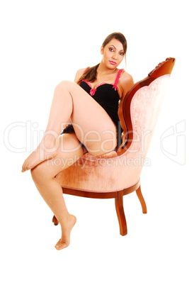 Girl sitting in pink armchair. Girl sitting in pink armchair.