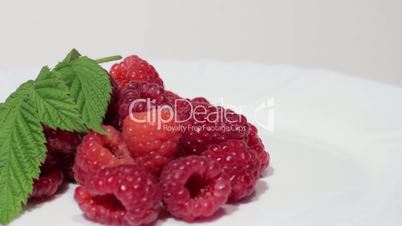 Bunch of a red raspberry on a white background.