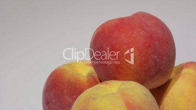 Ripe peach fruit on white background.