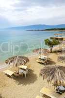 sunbeds on the beach at modern luxury hotel, peloponnes, greece
