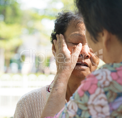 Consoling crying old mother