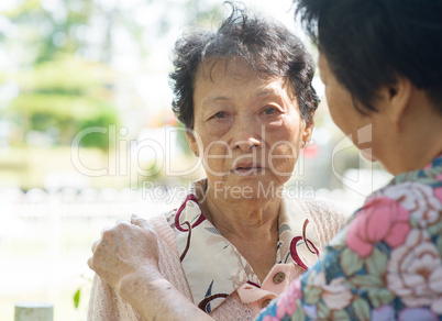Mature woman consoling her crying old mother