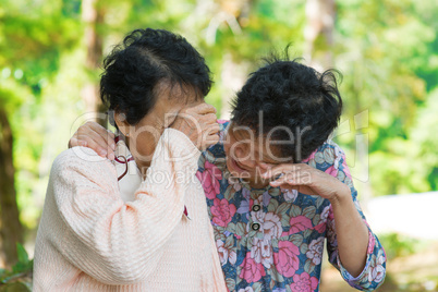 Sad senior Asian women