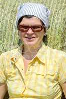 Farmer sitting in front of hay bales