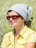 Farmer sitting in front of hay bales