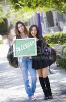 Mixed Race Female Students Holding Chalkboard With Success Writt