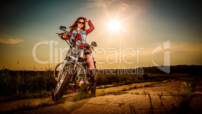 Biker girl sitting on motorcycle