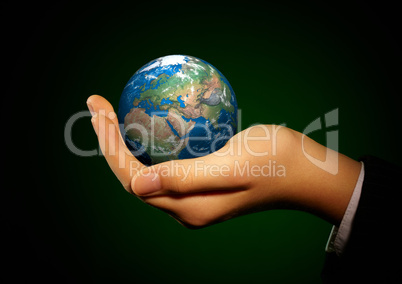 Hand of the person holds globe.
