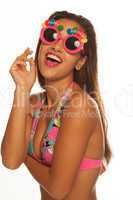 girl celebrating wearing birthday sunglasses on white