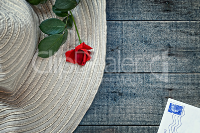 Womans summer hat with red rose and postcard