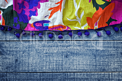 Multicolored womans skirt against blue wooden background